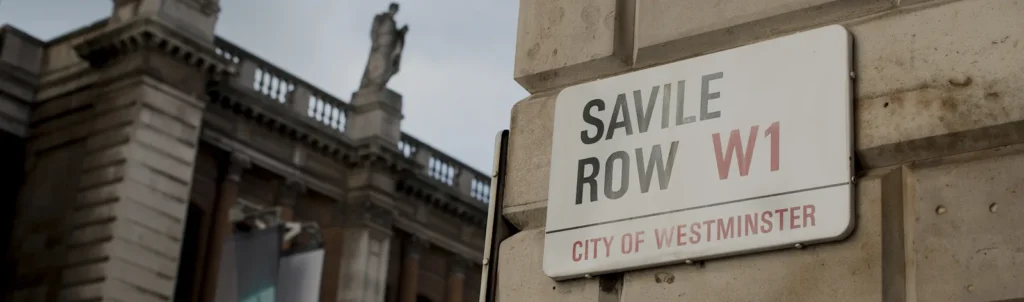The Savile Row street sign on a stone building in the City of Westminster
